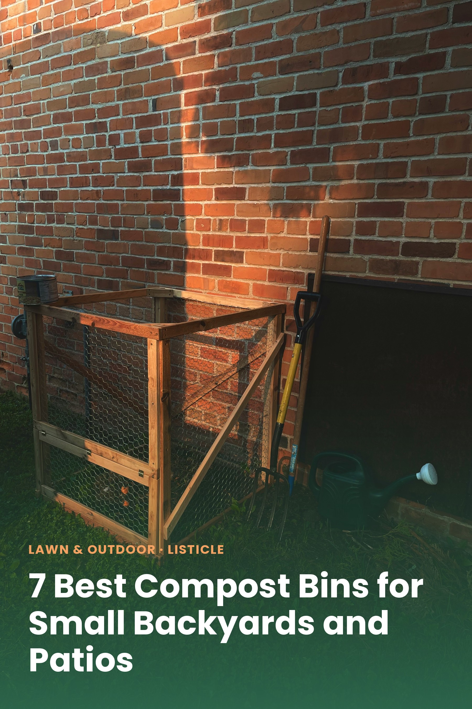A DIY wire-and-wood compost bin against a brick wall in a backyard