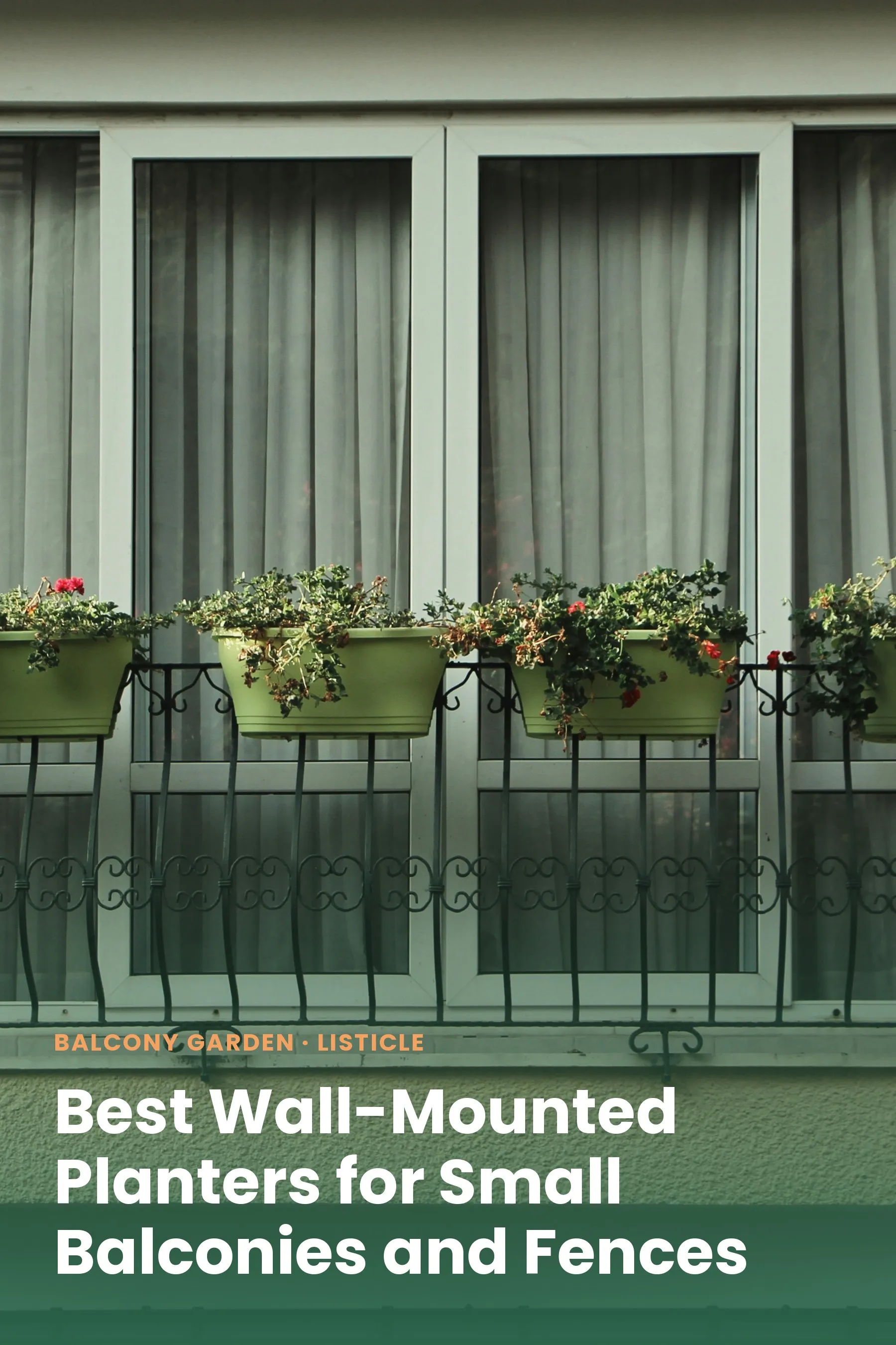 Green planters mounted on a balcony railing outside a window, filled with flowers