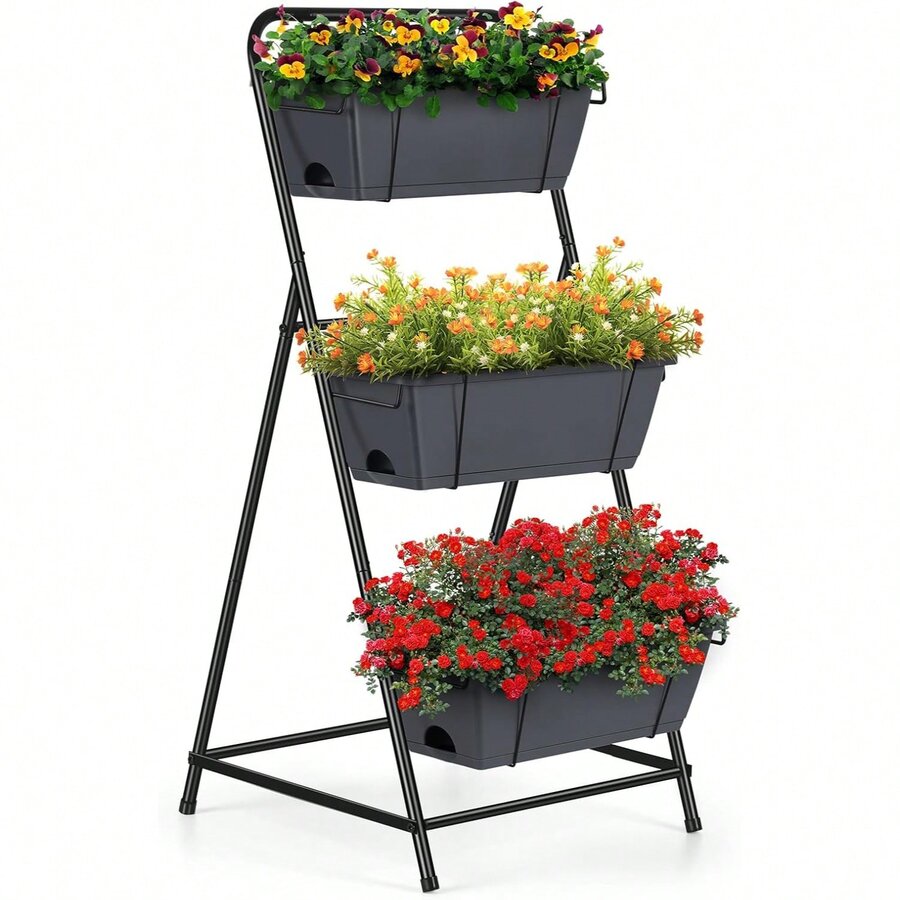 Black metal 3-tier vertical garden planter with stair-stepped boxes, freestanding on legs, planted with flowers