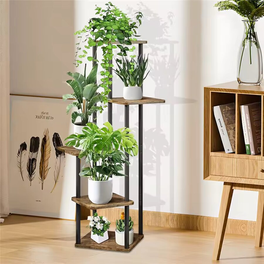 Multi-tier corner plant stand with staggered wood shelf platforms and black metal frame, displaying potted plants