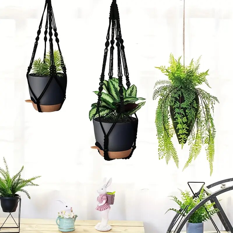 Three Bouqlife macrame plant hangers of different lengths, each holding a plastic pot, with box and hooks included