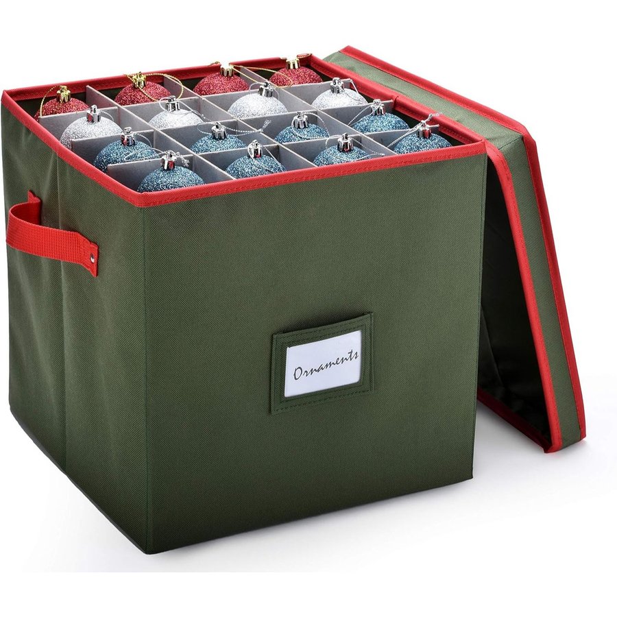 Green fabric ornament storage box with red trim, lid propped open over a grid of ornament dividers