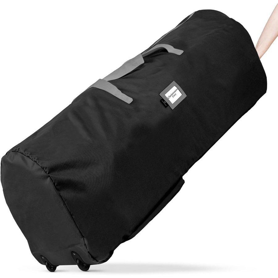 Black zippered rolling Christmas tree storage bag lying on its side with wheels and carry handles