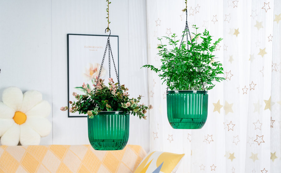 Two Melphoe green hanging planters of different sizes, suspended by chains, with built-in reservoirs