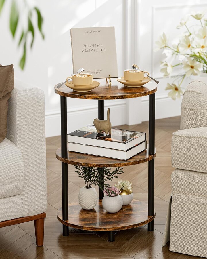 Small round rustic wood-and-black-metal 3-tier accent table beside an armchair