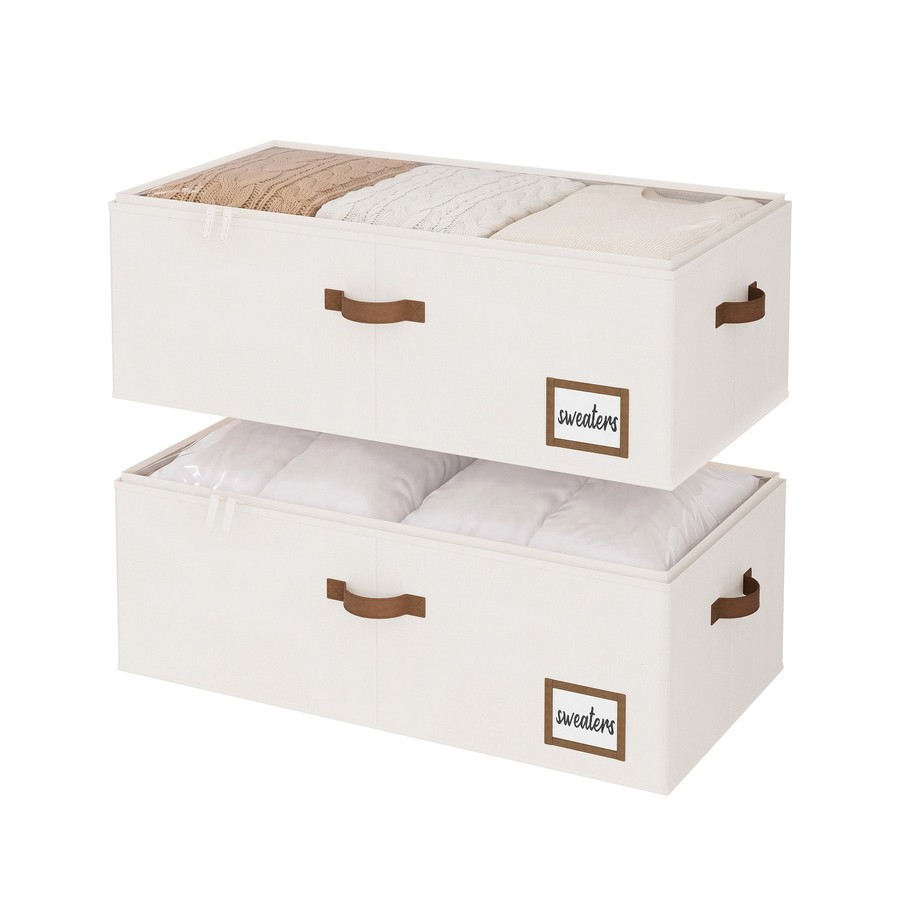 Two stacked cream fabric under-bed storage boxes with clear tops and leather handles
